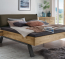 Modernes Massivholzbett Neras mit umgedrehter Holzkufe - hier mit Stoff-Kopfteil Modernes Massivholzbett Neras mit umgedrehter Holzkufe, hier mit Stoff-Kopfteil