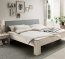 Massivholzbett mit Polsterkopfteil in Stofffarbe lightgrey Massivholzbett mit Polsterkopfteil in Stofffarbe lightgrey